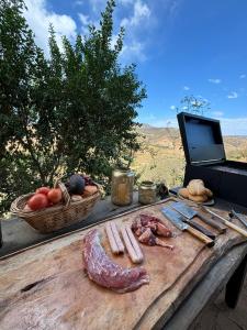 a wooden table with a cutting board with meat and vegetables at Residencia Artistica CasaVino in Casablanca