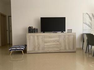 a television on top of a wooden cabinet in a living room at Poesia di Lerici in Lerici