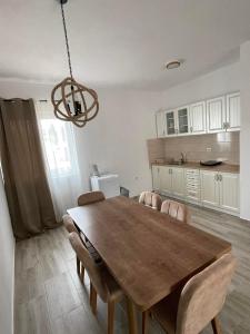 a dining room table and chairs in a kitchen at Darija in Dobra Voda