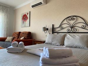 Una habitación de hotel con una cama con toallas. en Apartamentos Benal Beach Group, en Benalmádena 11 fotos más