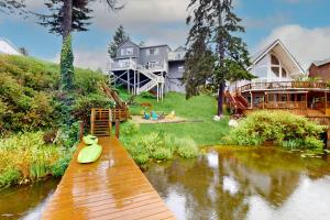 a house with a dock with a toy duck on it at Lazy Lookout on Devils Lake in Lincoln City
