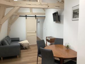 een woonkamer met een tafel en een bank bij Maison cœur de Chablis in Chablis