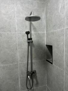 a shower with a shower head in a bathroom at Seven Day in Bishkek