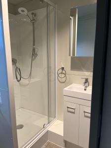 a bathroom with a shower and a sink at Suite Ten10 in Te Awamutu