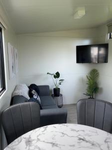 a living room with a couch and a table at Suite Ten10 in Te Awamutu