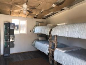 two bunk beds in a room with a ceiling at Checkpoint in Rosarito