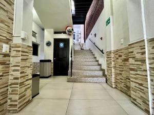 a hallway of a building with stairs and a door at Hotel Juarez 70 in Colima