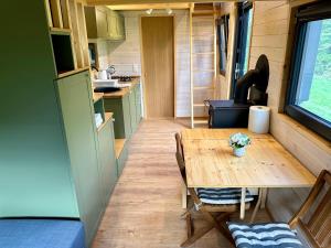 a small kitchen with a table in a tiny house at Tiny Home in Dejani