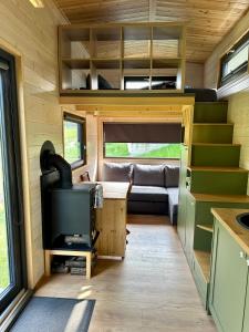 a tiny house with a kitchen and a living room at Tiny Home in Dejani