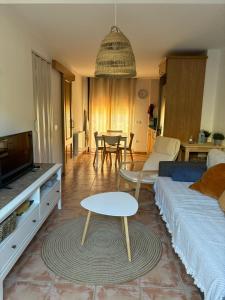 a living room with a couch and a table at Casa ELENA i MARTA , Valdelinares in Valdelinares