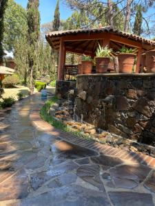 a stone retaining wall with a water fountain at Magnolia in Mazamitla