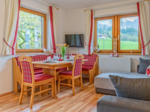 a living room with a table and chairs and a couch at Johanna in Reith im Alpbachtal