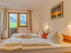 a large white bed in a room with a window at Johanna in Reith im Alpbachtal