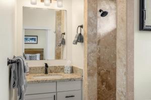 a bathroom with a sink and a shower at Kolepa Kai in Koloa +41 photos