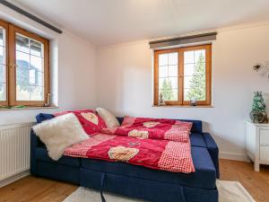 um quarto com uma cama azul e um cobertor vermelho em Chalet one em Kitzbühel