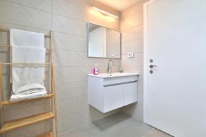 a bathroom with a sink and a mirror at Luxury apartment on the beach in Haifa +21 photos