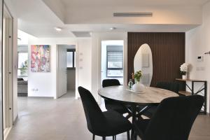 a dining room with a table and chairs at Luxury apartment on the beach in Haifa