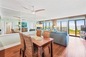 a living room with a table and a couch at Poipu Shores 101A in Koloa