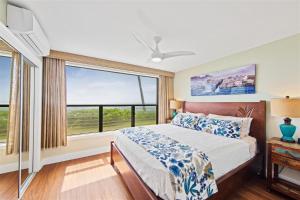 a bedroom with a bed and a large window at Poipu Shores 101A in Koloa +31 photos