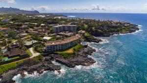 an aerial view of a resort on the shore of the ocean at Poipu Shores 101A in Koloa