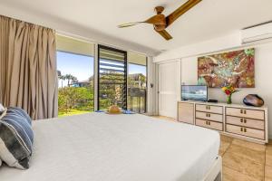 a bedroom with a large bed and a large window at Makahuena 1204 Ocean View in Koloa +35 photos