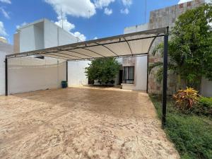an empty garage with awning outside of a building at Casa Dzitya in Mérida