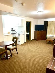 a large room with a kitchen and a table and chairs at Super 8 by Wyndham Hinton in Hinton
