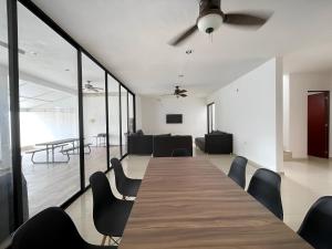a conference room with a long table and chairs at Casa Dzitya in Mérida +26 photos