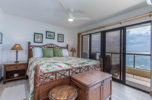a bedroom with a bed with a view of the ocean at Poipu Shores 207A in Koloa +22 photos