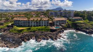an aerial view of a resort on a rocky coastline at Poipu Shores 207A in Koloa