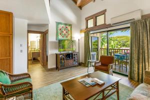 a living room with a couch and a table at Waikomo Stream Villas 332 in Koloa