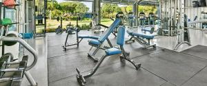 a gym with blue chairs and people in the background at Waikomo Stream Villas 332 in Koloa