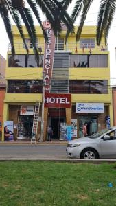a hotel with a car parked in front of it at Hotel Residencial C´BASTIAN in Tacna