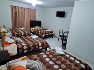 Postel nebo postele na pokoji v ubytování Hotel Residencial C´BASTIAN
