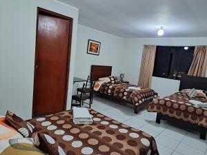 Postel nebo postele na pokoji v ubytování Hotel Residencial C´BASTIAN
