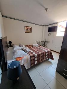 Postel nebo postele na pokoji v ubytování Hotel Residencial C´BASTIAN
