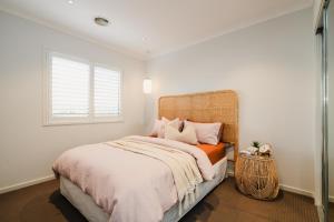 a bedroom with a large bed and a window at Hamptons Haven Luxe 4 bedroom, 2 bathroom, WIFI, Great for wedding stays Managed by Host On The Coast in Mount Duneed