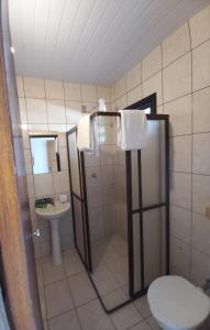 a bathroom with a shower and a toilet and a sink at Lofts Visconde in Joinville