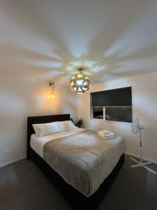 a bedroom with a large bed with a ceiling at Haven in Hanley's in Frankton Wharf
