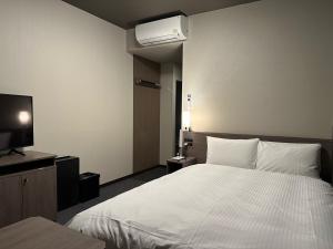 Voodi või voodid majutusasutuse Hotel Route Inn Numata toas