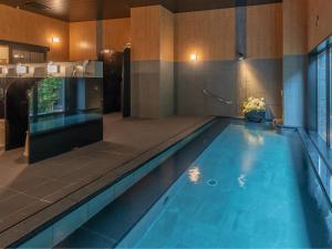 a large swimming pool in a room with at Hotel Route Inn Numata in Numata