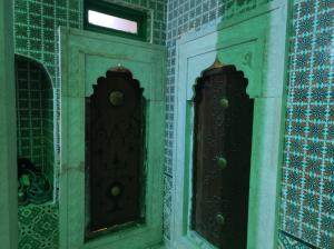 two brown doors in a room with blue tiles at Dar Tayeb in Tunis