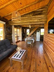 a living room with a couch and a table at Cabaña La Maura in La Estancia