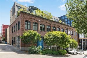 a brick building with plants on the top of it at Massive Downtown Seattle Condo - Free Parking! in Seattle