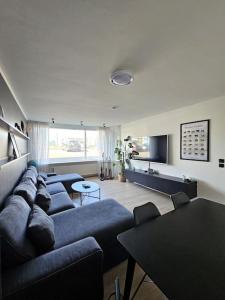 a living room with blue couches and a table at Apartment near Reykjavik's heart in Reykjavík