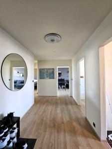 an empty living room with a large mirror on the wall at Apartment near Reykjavik's heart in Reykjavík