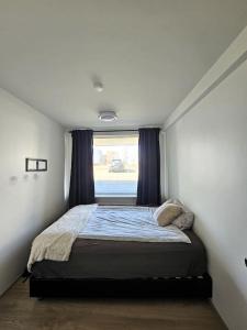 a bed in a room with a window at Apartment near Reykjavik's heart in Reykjavík