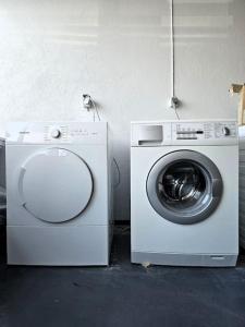 a washing machine sitting next to a white washer at Apartment near Reykjavik's heart in Reykjavík