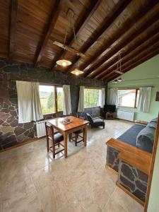 a living room with a table and a couch at KaiKen Lauquen in Trevelin