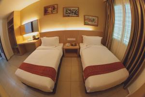 Voodi või voodid majutusasutuse Paragon Lutong Hotel toas